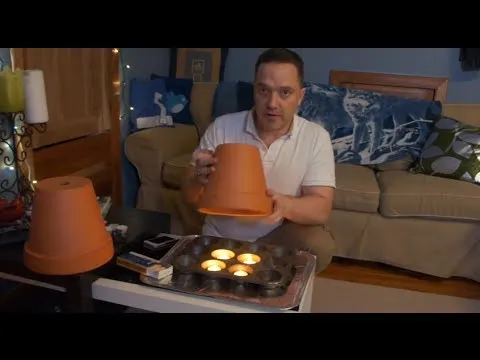 Person demonstrating a DIY project using clay pots indoors.