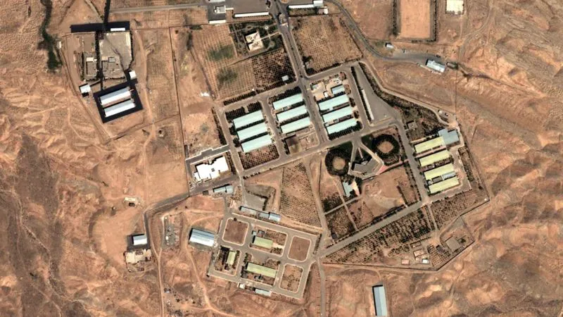 Aerial view of a large industrial complex in a desert landscape.