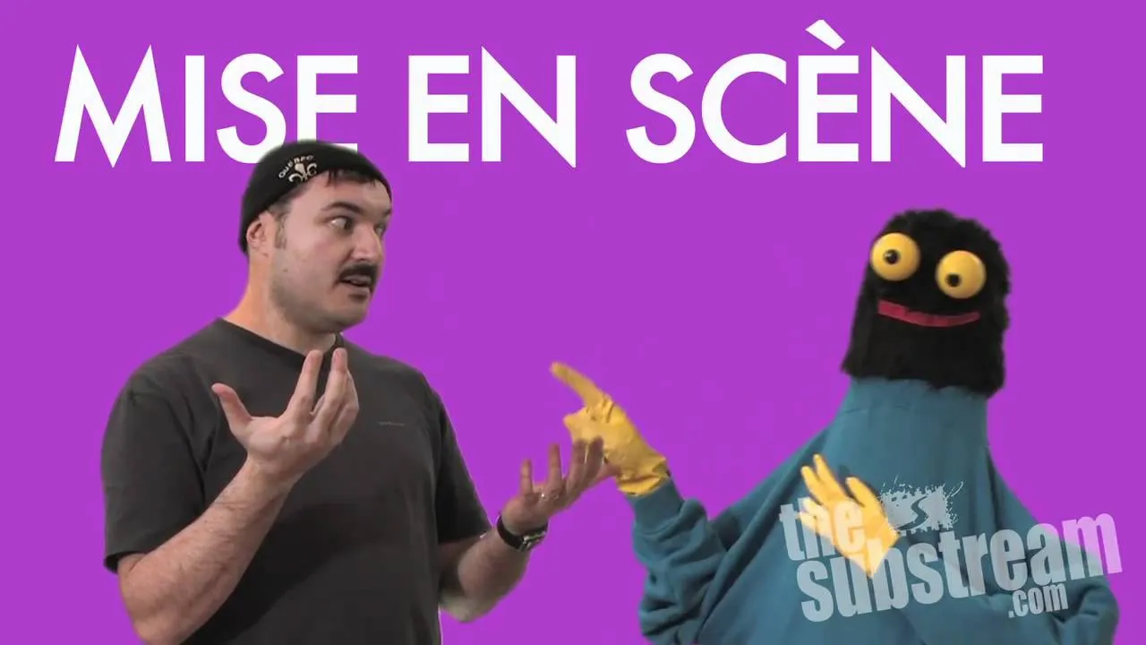 A person and a puppet engaging in an animated conversation against a purple background.
