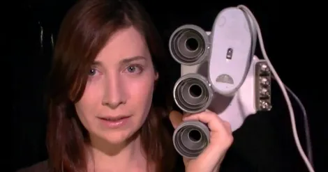 Woman holding a vintage viewer device.
