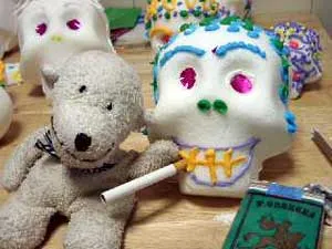 Creative plush toys featuring a bear and a decorated skull.