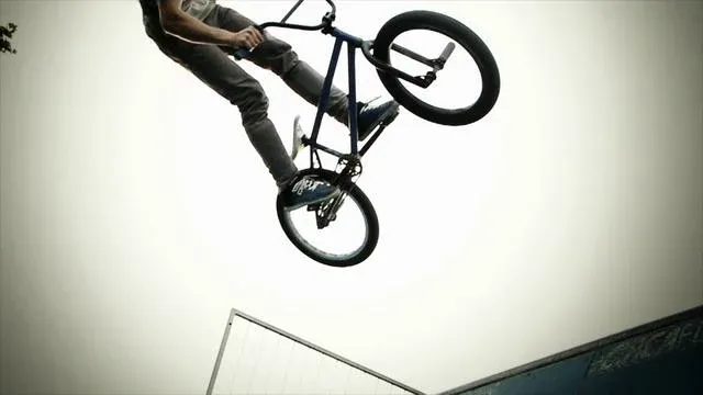 BMX rider performing a jump in mid-air.