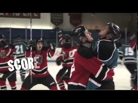 Hockey players celebrating a goal on the ice.