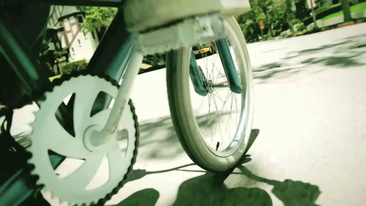 Bicycle wheel and chain on a smooth pavement.