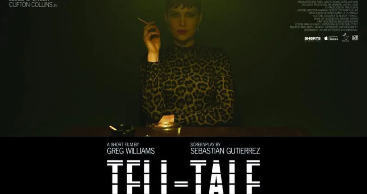 A person in a dimly lit room holding a cigarette, with text overlay for the short film "Tell-Tale."