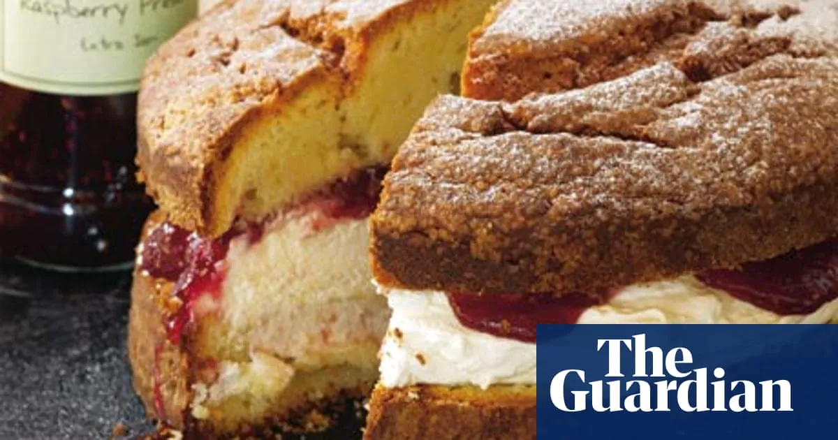 Sliced cake with cream and raspberry filling.