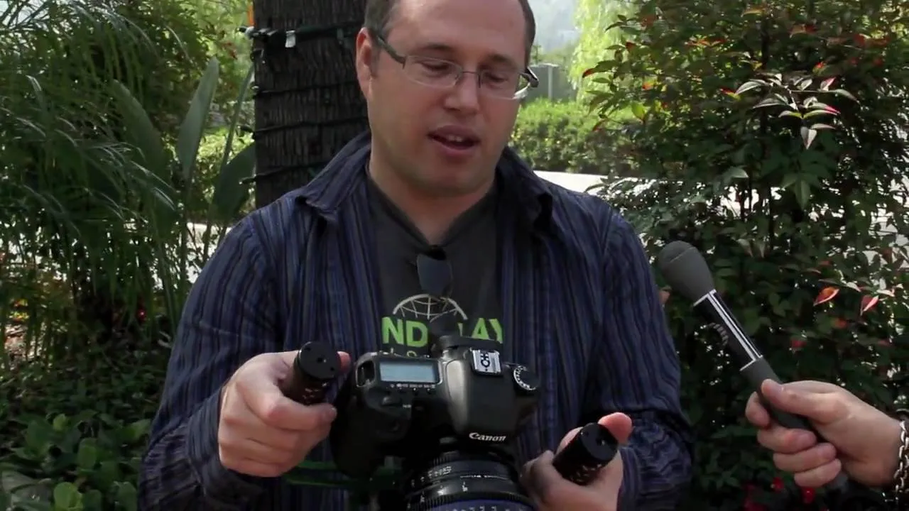 Photographer holding a camera outdoors.
