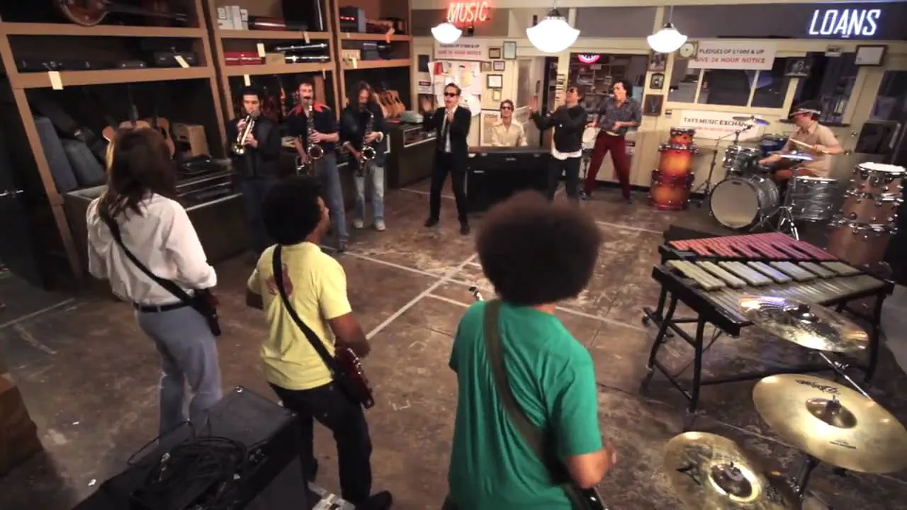 A group of musicians performing in a studio setting.