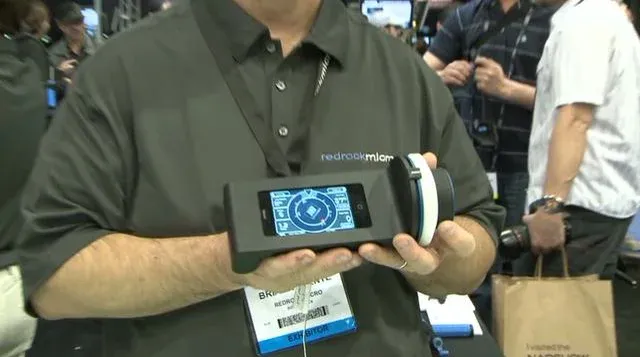 Person holding a portable device at a technology expo.
