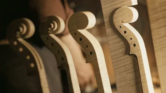 Wooden instrument necks in a workshop setting.