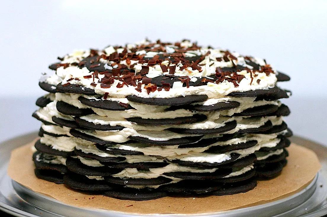 Chocolate layered dessert with cream and cookie layers.