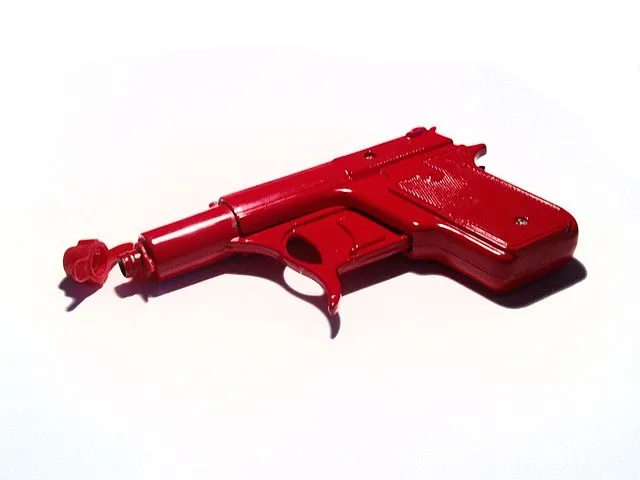 Red toy water gun on a white background.