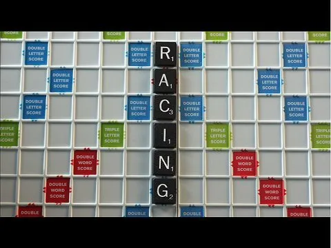 Scrabble tiles spelling "RACING" on a game board.