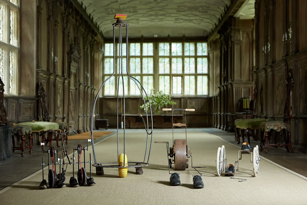 Artistic display of various exercise equipment in a grand hall.