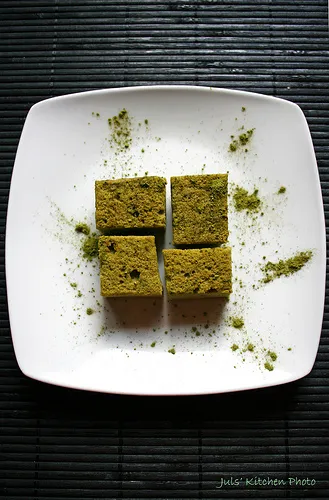 Pistachio baklava pieces arranged on a white plate.
