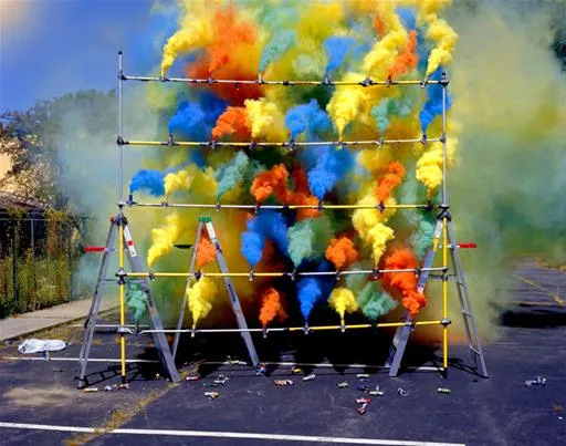 Colorful smoke explosion against a blue sky.