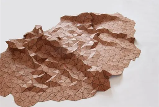 Textured origami sculpture with a geometric design.