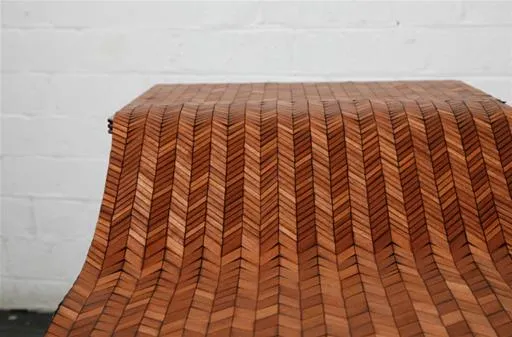 Wooden herringbone-patterned surface.