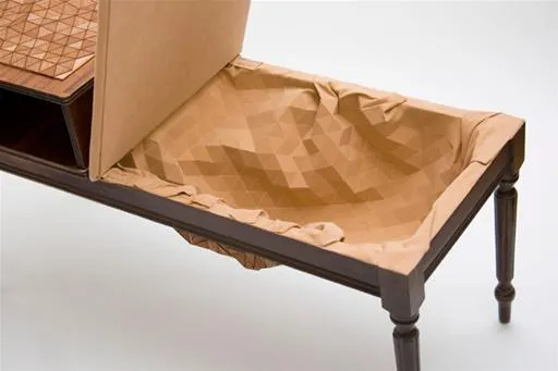 Unique wooden table with an open drawer and crumpled paper lining.