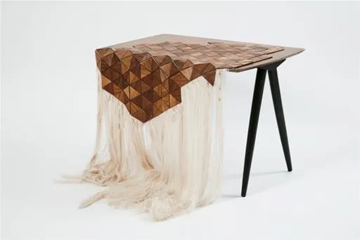 Geometric wooden table with fabric draping.