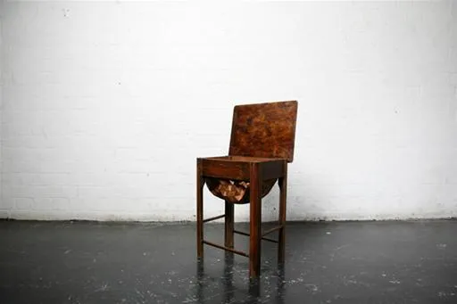 Wooden chair with a unique design on a minimalist background.