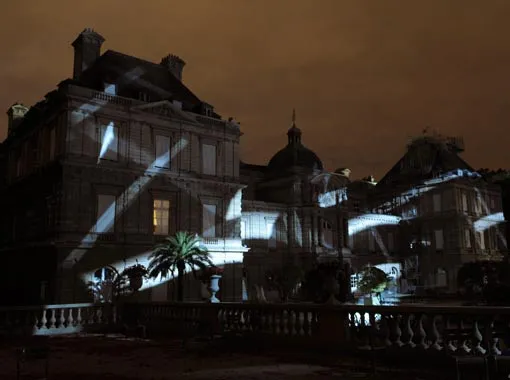 Historic building illuminated at night with dramatic lighting.