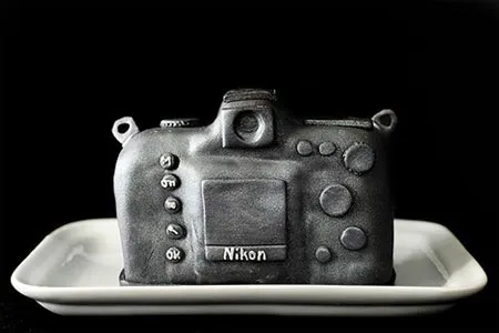 Camera-shaped cake designed to resemble a Nikon camera.