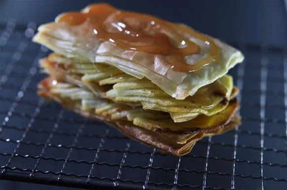 Layered pastry dessert with caramel drizzle.