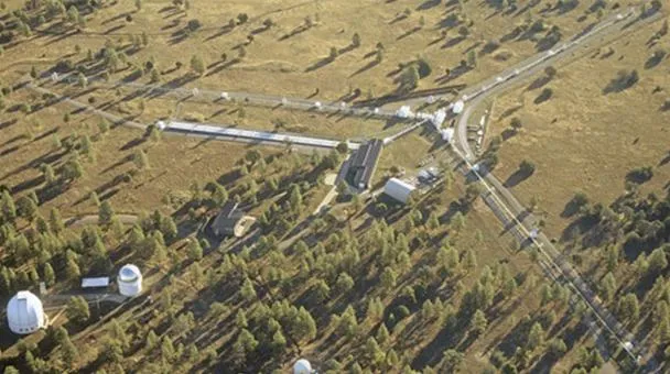 Aerial view of a remote observatory surrounded by trees and open fields.