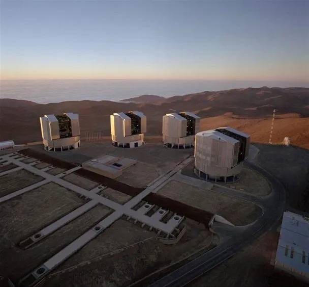 Observatory telescopes on a mountain top during sunset.
