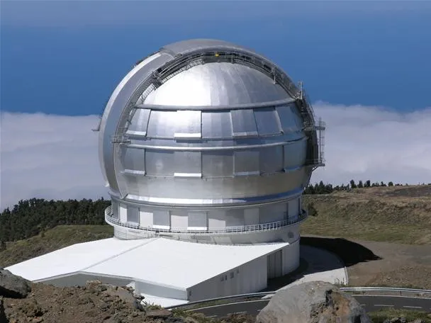 Observatory dome on a mountain overlooking the ocean.