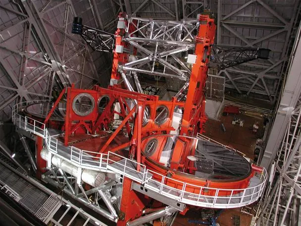 Large astronomical telescope structure inside an observatory.