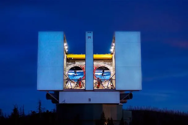 Observatory structure with telescopes under a night sky.