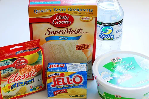 Baking ingredients including cake mix, gelatin, powdered sugar, and water.