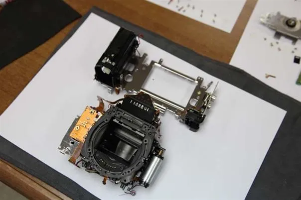 Disassembled camera components on a work surface.