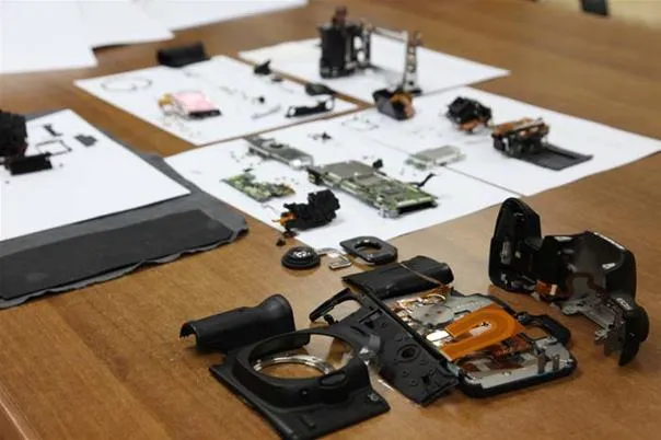 Disassembled camera parts organized on a table.