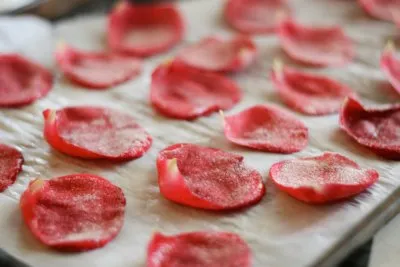Thinly sliced meat arranged on parchment paper.