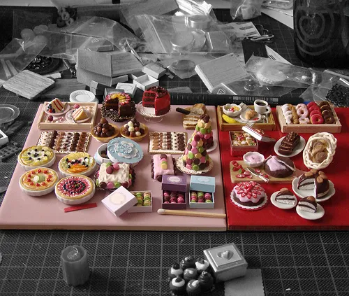 Colorful display of miniature desserts arranged on two contrasting backgrounds.