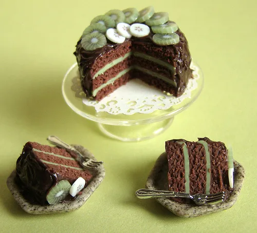 Chocolate layer cake with slices displayed on a decorative plate.