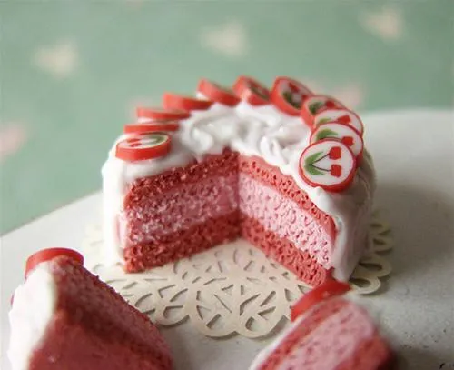 Strawberry cake with icing and decorative slices.