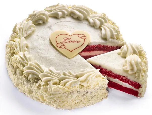 Red velvet cake with cream cheese frosting and a decorative "Love" heart.