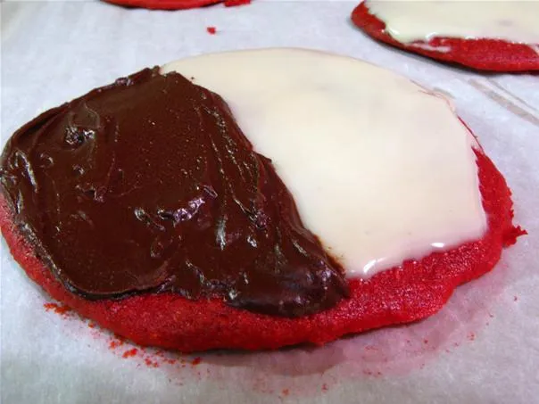 Red velvet cookie topped with chocolate and vanilla icing.