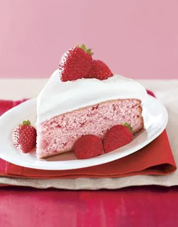 Strawberry mousse cake slice with fresh strawberries on top.