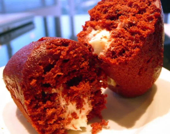 Red velvet cake with cream cheese filling, cut in half.