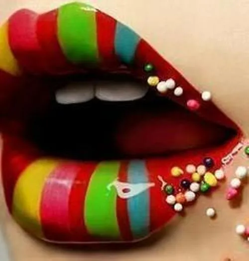 Colorfully striped lips with decorative sprinkles.