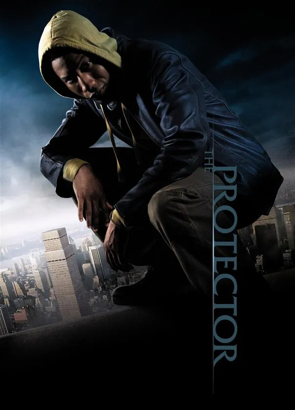 Young man in a hoodie crouching with a city skyline in the background.