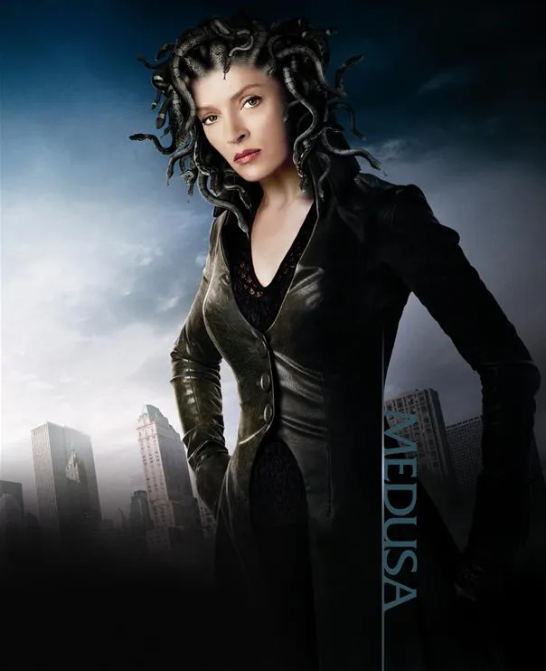 Woman with snake-like hair in a dark outfit, posing confidently.