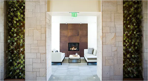 Contemporary living space with a fireplace and green wall accents.
