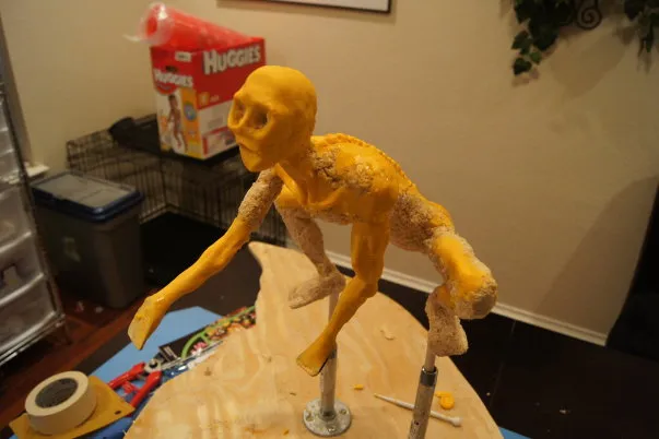Artistic sculpture of a humanoid figure made from modeling material.