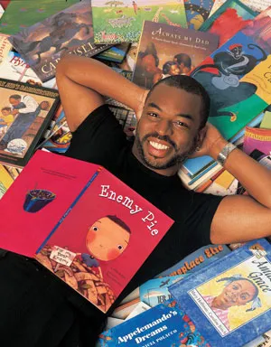 A person lounging on a colorful array of children's books.